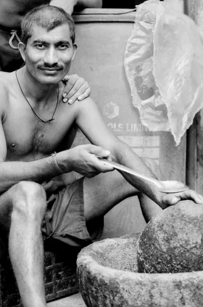 Man crushing spices in mortar