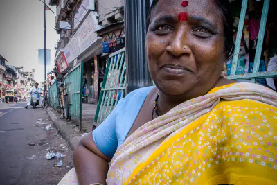 Chubby woman in a saree sitting by the roadside