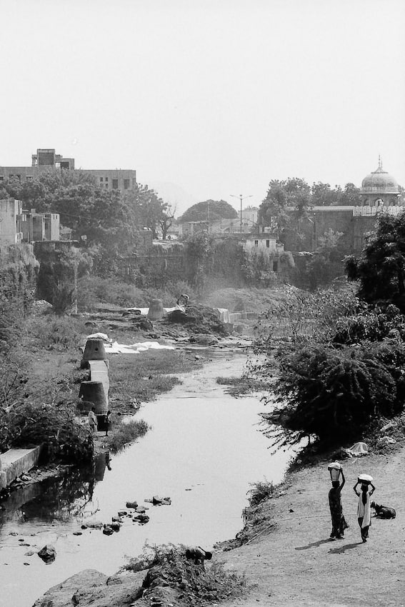 Two figures on riverside