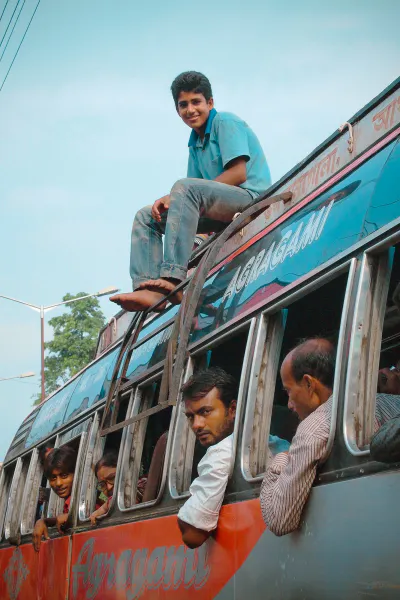 Young man on roof of bus