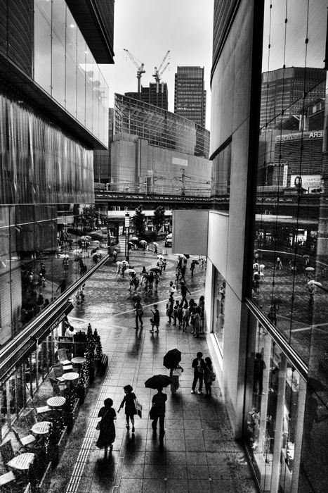 Silhouettes walking between buildings