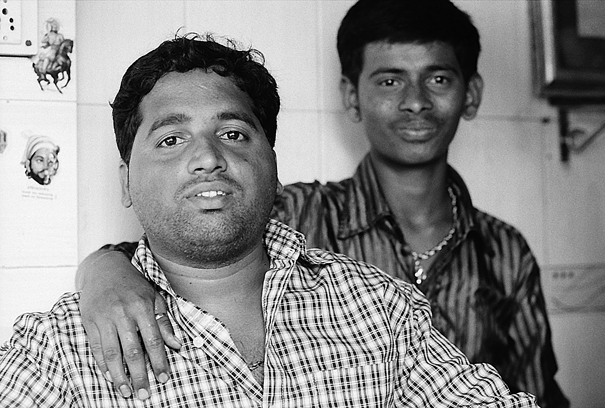 Two Men Relaxing In A Shop (India)