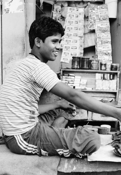Young Tobacconist In A Corner Of A Street (India)