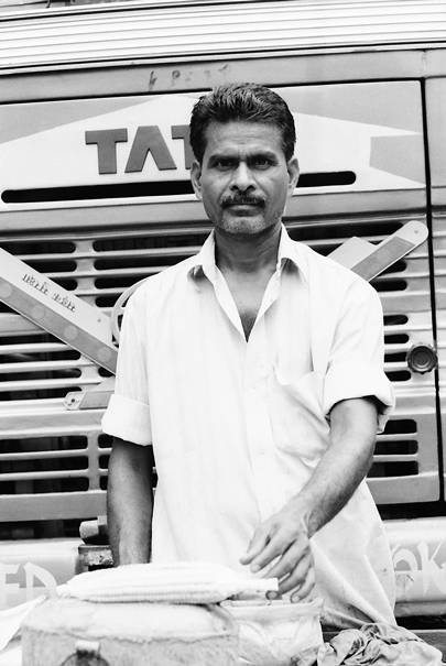 Man Toasiting In Front Of A Truck (India)