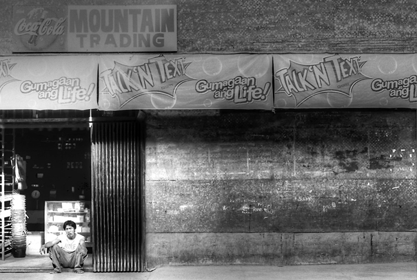 Man Sitting At A Storefront (Philippines)