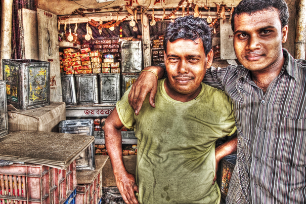 Two Men Standing Together In A Shop (India)