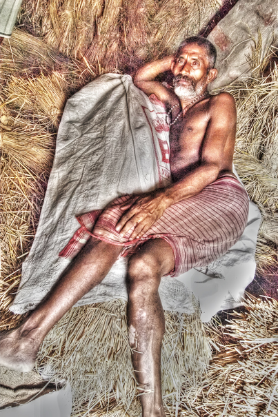Man Lying Down On The Wheat Straw (India)