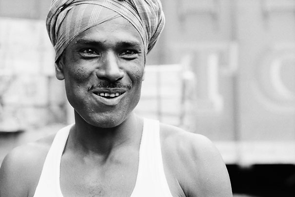 Smiling Laborer Wrapping Cloth Around His Head (India)