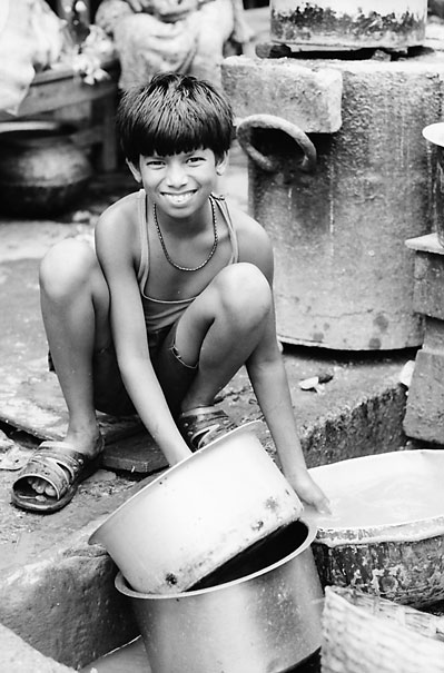 Boy Scrubbing Pans (India)