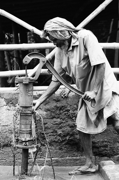 Man Getting Some Water From A Well (India)