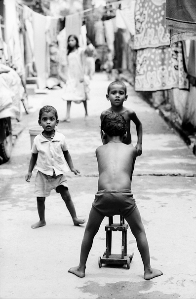 Shoeless Boys Playing In The Lane (India)