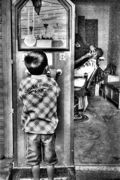 Boy In Front Of A Barber (India)