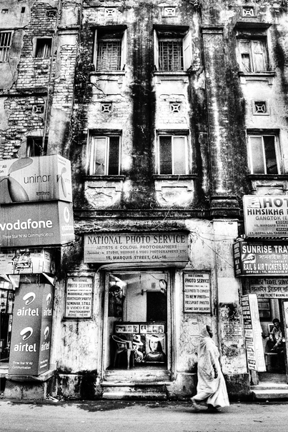 Woman Walking In Front Of A Building (India)