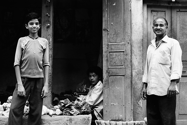 Two Standing Men And A Sitting Man (Nepal)