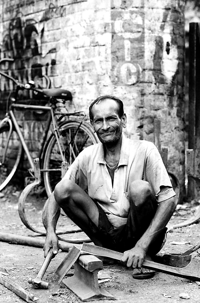 Hammer And Scrap Iron In His Hand (India)