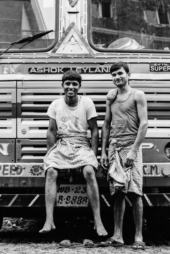 Two men in front of truck