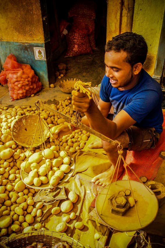 Man weighing potatoes