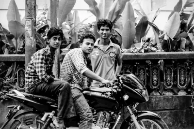 Three men around motorbike