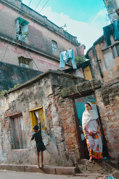 Woman and boy standing in front of a house