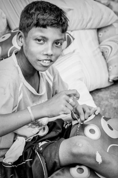 Boy sewing cushion
