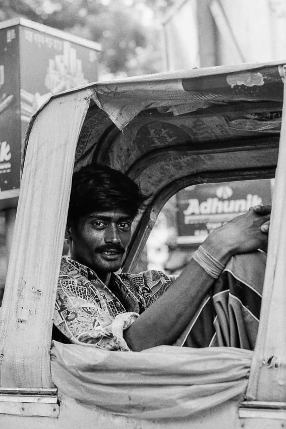 Rickshaw wallah relaxing on seat
