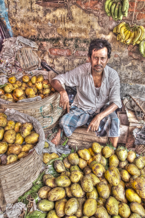 Man surrounded by mangoes