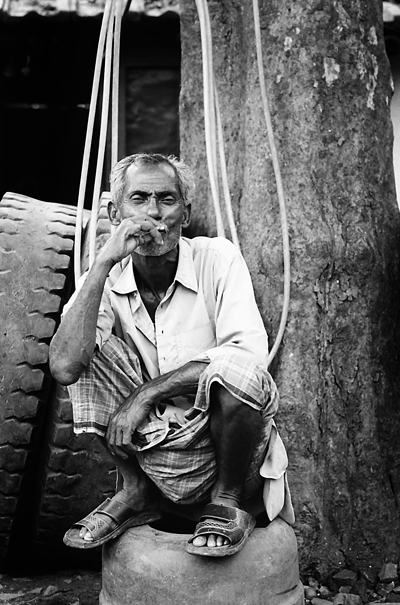 Smoking Man On The Old Tire (India)