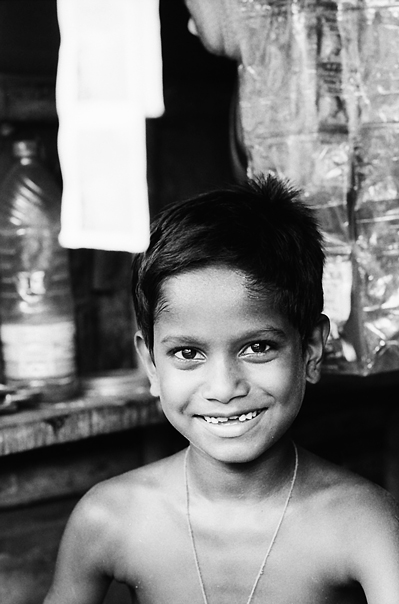Boy Working At A Small Shop (India)