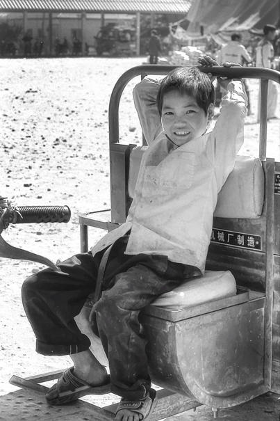 Boy sitting on tractor