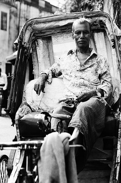 Man Sitting On A Cycle Rickshaw (India)