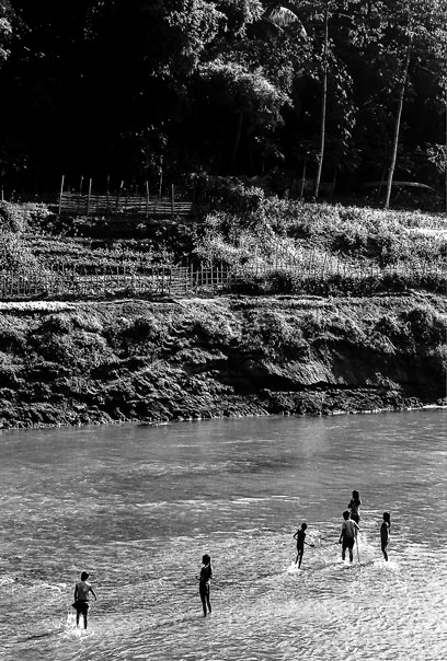Silhouettes In The Shallow Water (Laos)