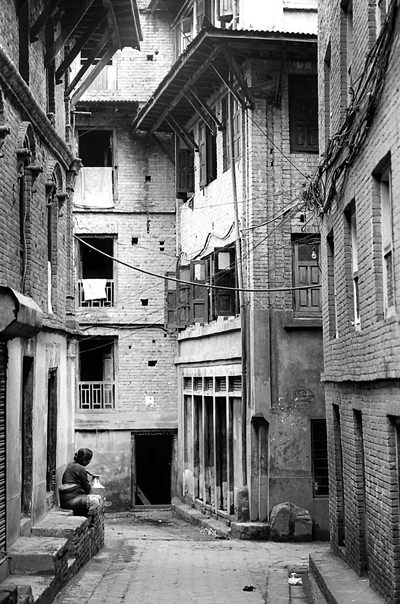 Woman In A Corner Of A Lane (Nepal)