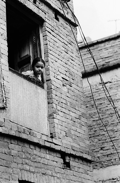 Girl leaning out from window