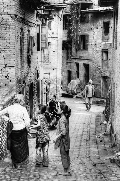 Older Woman And Two Girls In The Lane (Nepal)