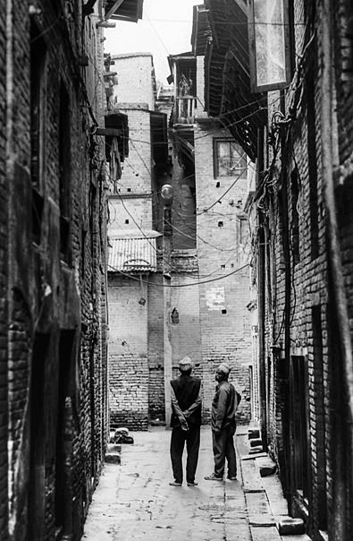 Two Men Between Buildings (Nepal)