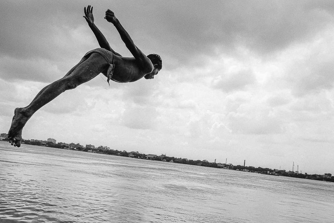 Boy jumping into the Hooghly River