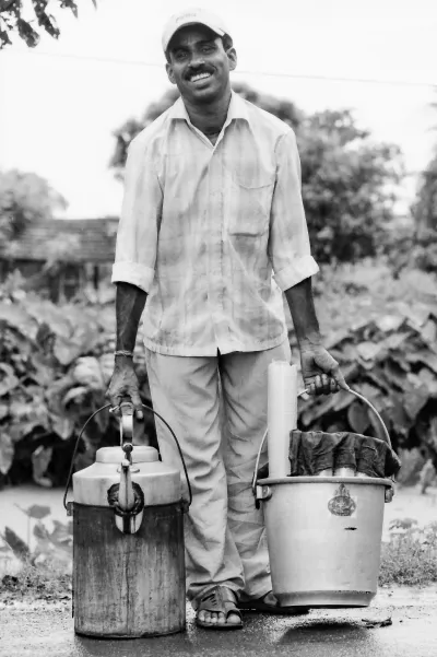 Man carrying a bucket and a kettle