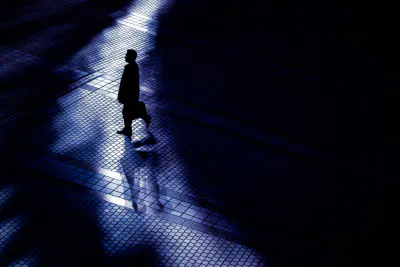 Silhouette walking among shadows