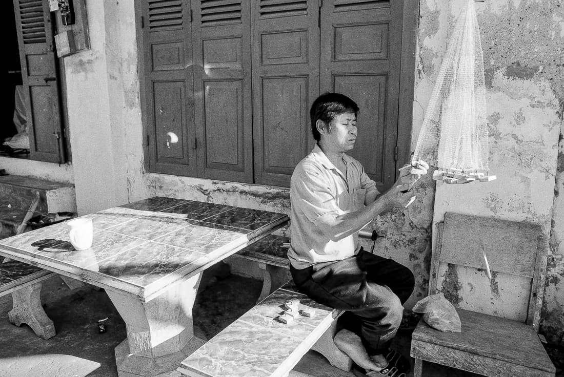 Man repairing fishing net