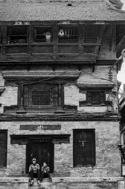 Man and boy in front of traditional house