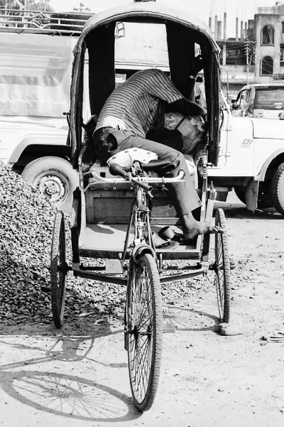 Rickshaw wallah sleeping on his rickshaw