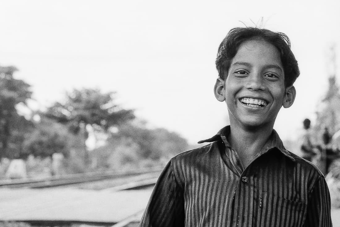 Boy smiling at railroad crossing