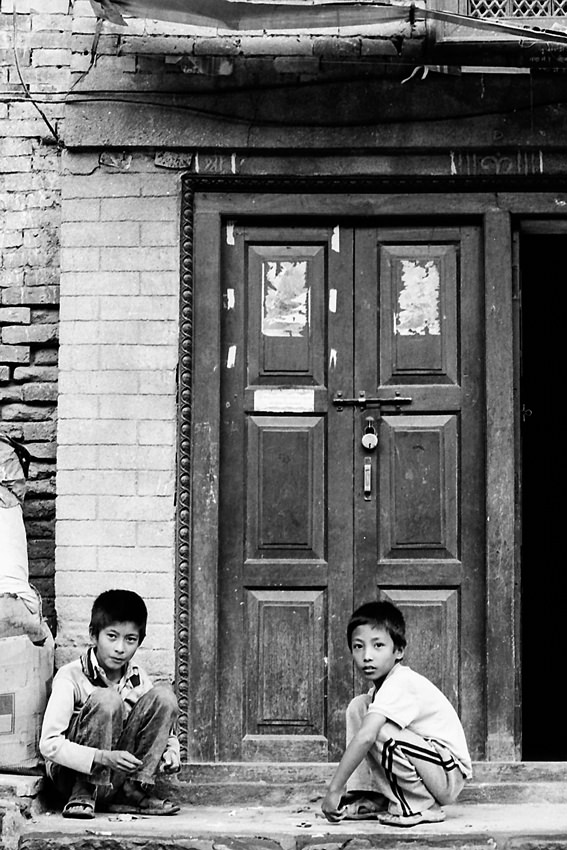 Two boys in front of door
