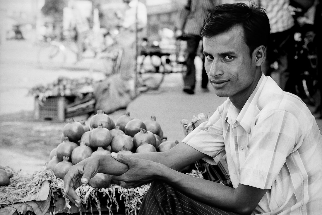 Man selling pomegranates