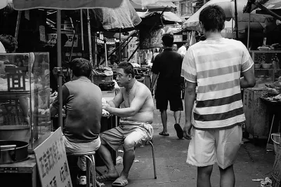 Topless man in food stall