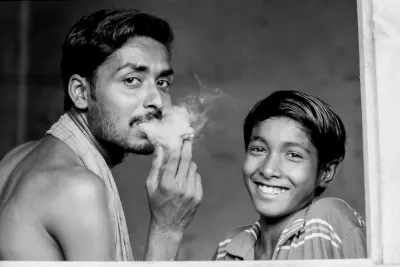 Smoking man and smiling boy