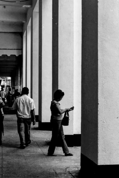 Silhouette of woman walking passage