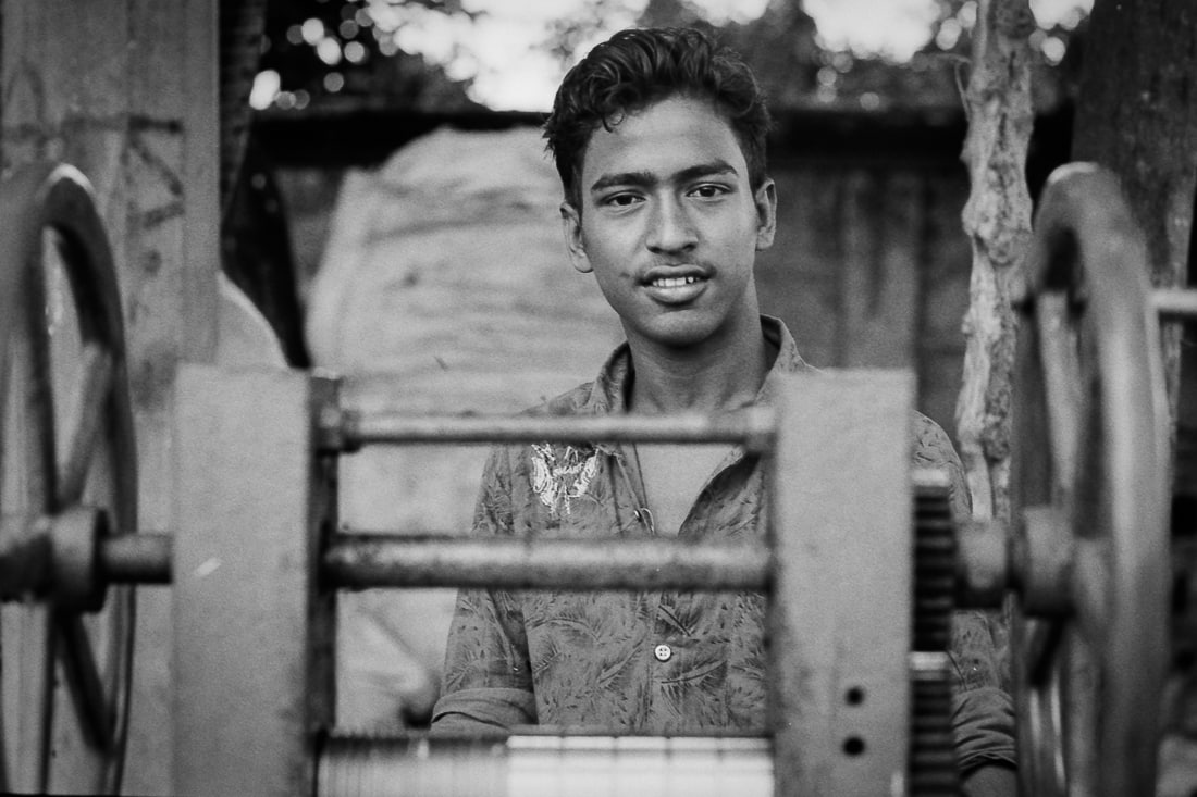 Young man selling fresh sugar cane juice