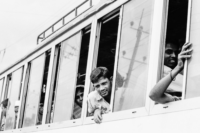 man leaning out from bus window