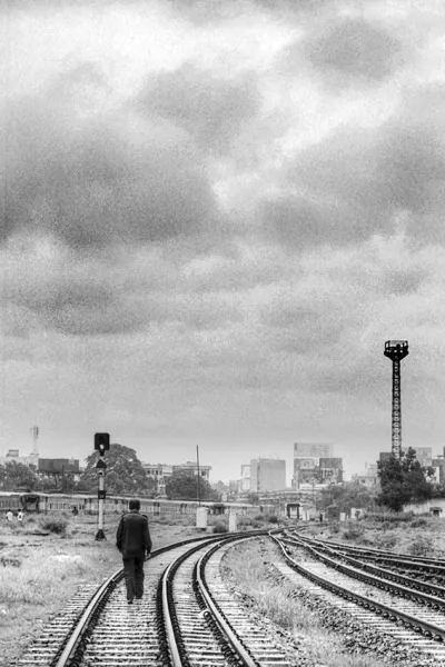 Man walking railway track